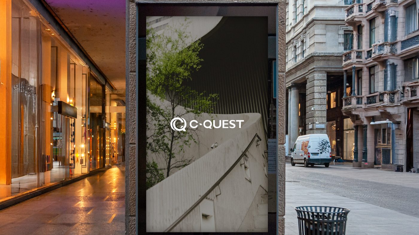 C-Quest street corner display featuring the C-QUEST wordmark over architectural staircase photography