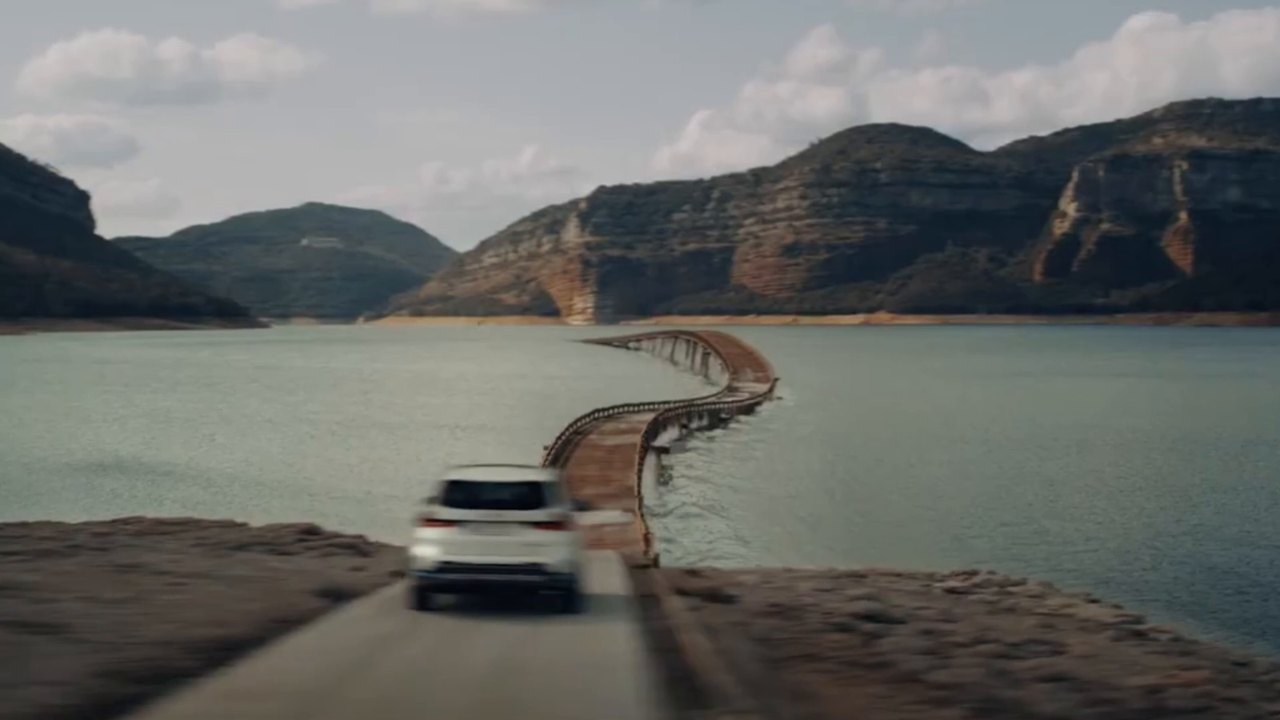 Cinematic BMW driving across a causeway, from the film